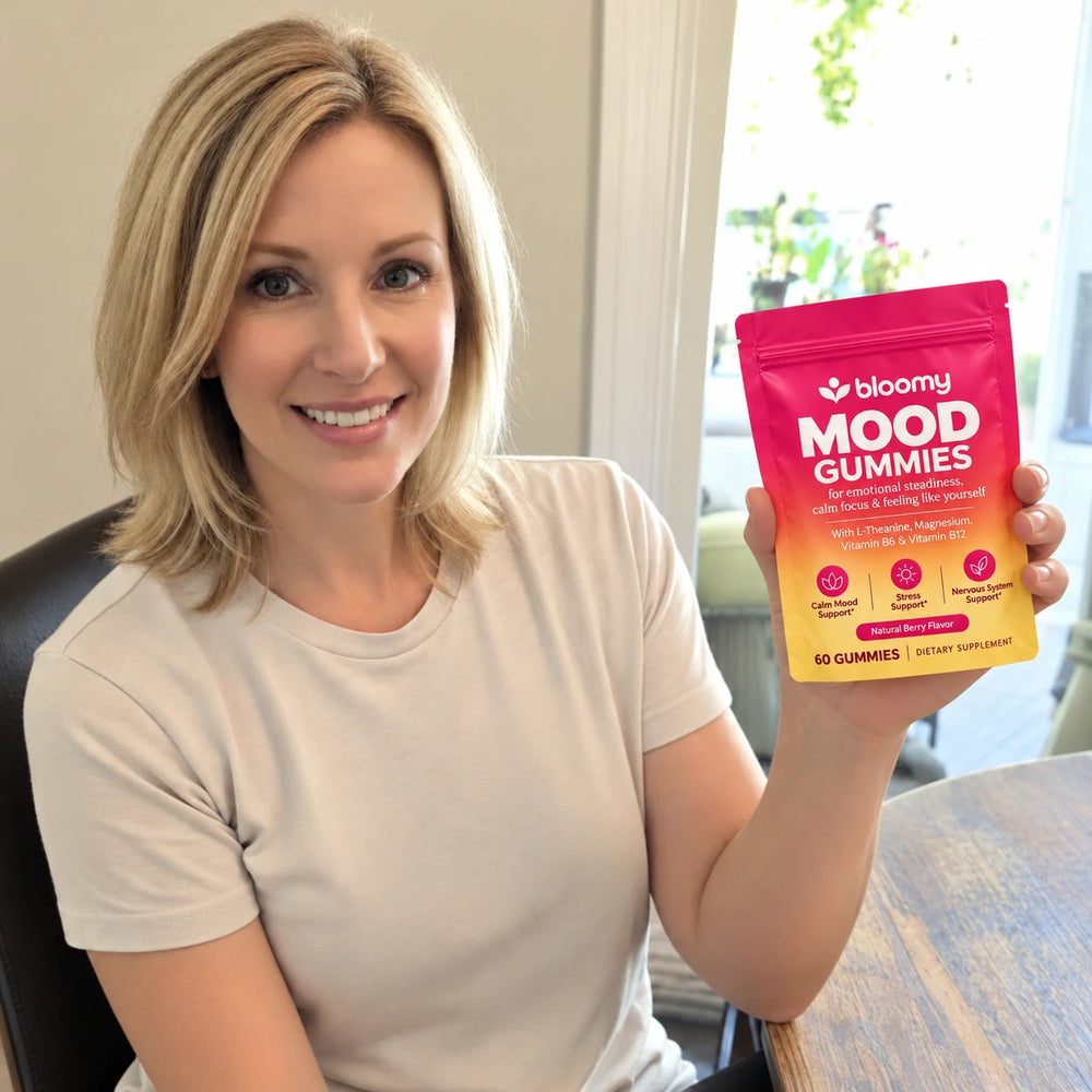Lifestyle photo of a woman holding a Bloomy Mood Gummies pouch