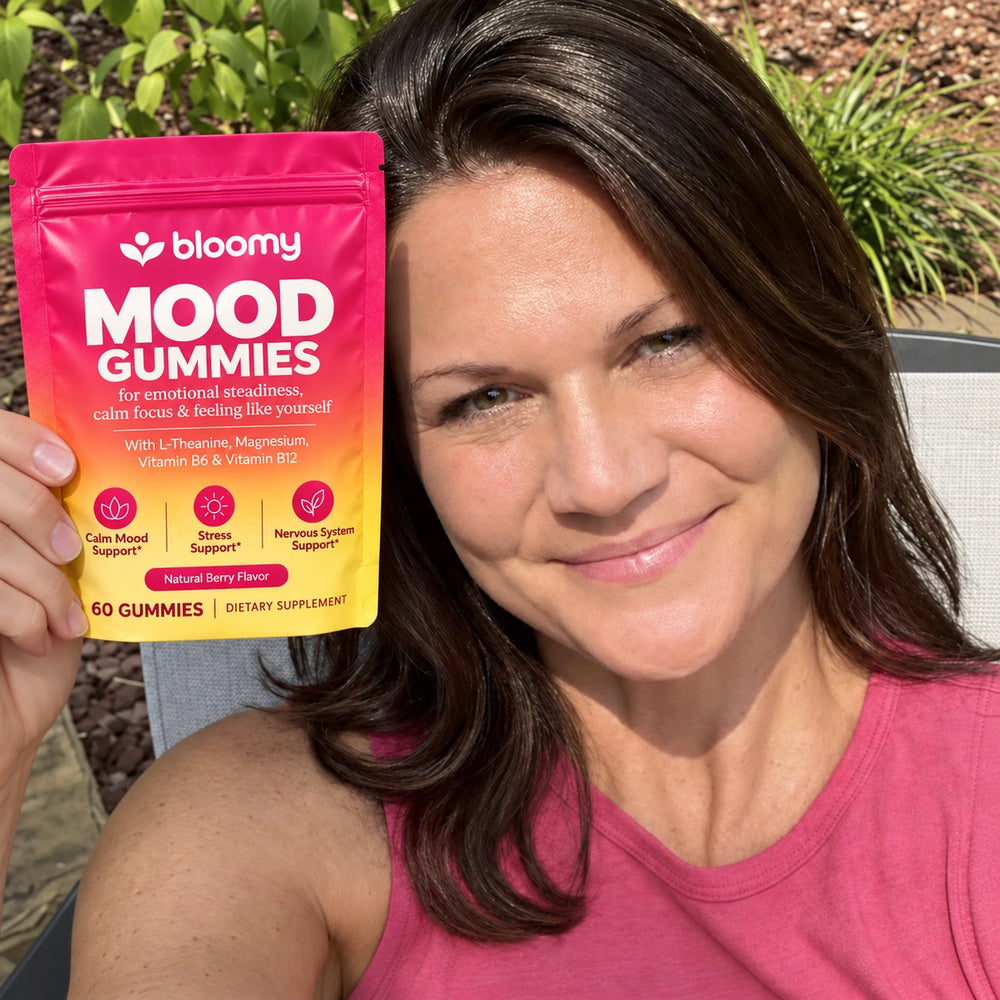 Lifestyle photo of a woman holding a Bloomy Mood Gummies pouch